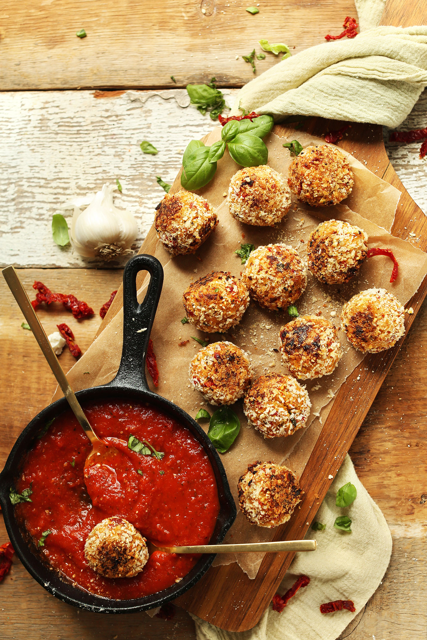 Platter of our healthy Vegan Arancini with a cast-iron skillet of warm marinara