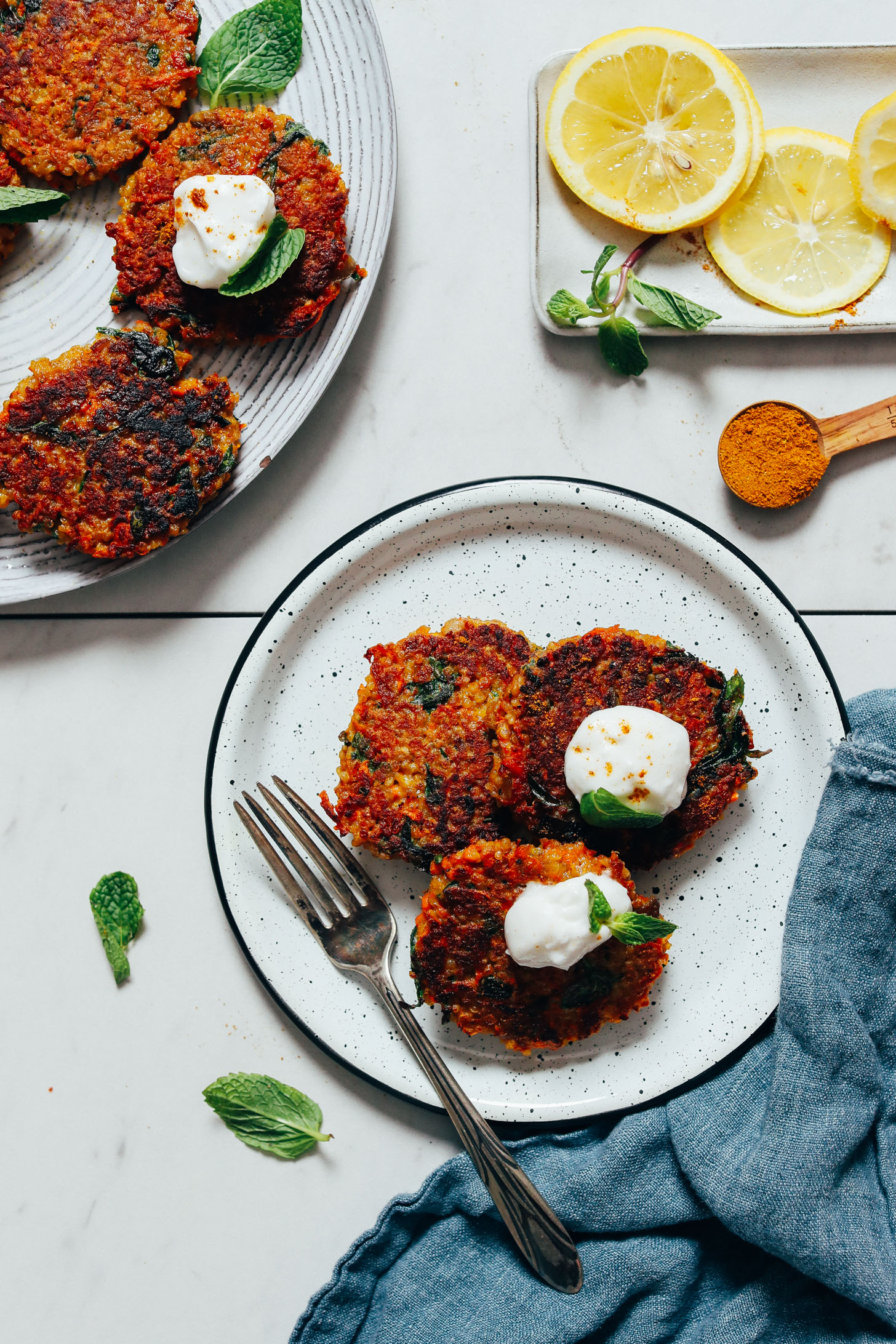 Plate of Quinoa Sweet Potato Fritters topped with dairy-free yogurt and fresh mint