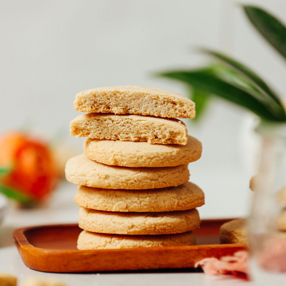 Sliced gluten free shortbread cookies on a stack of more cookies